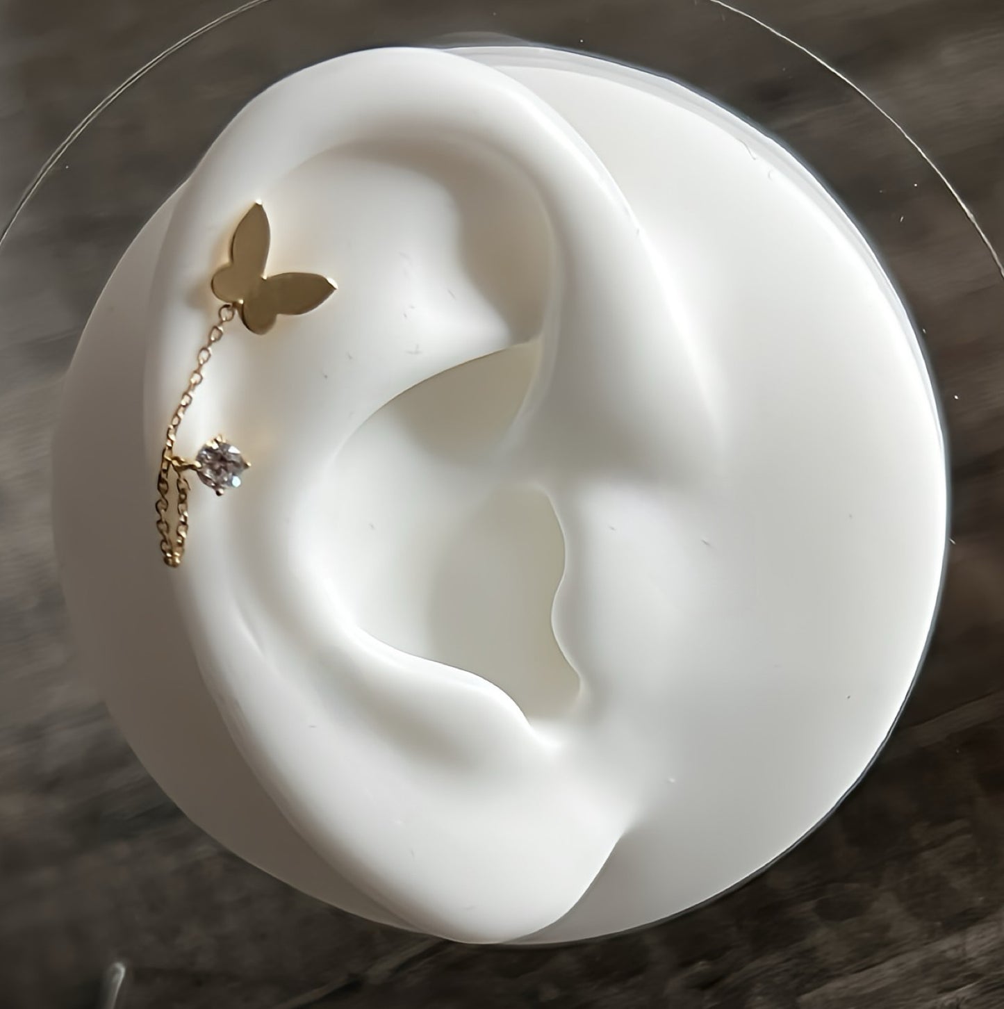 Butterfly and cubic zirconia mismatch drop stud earrings